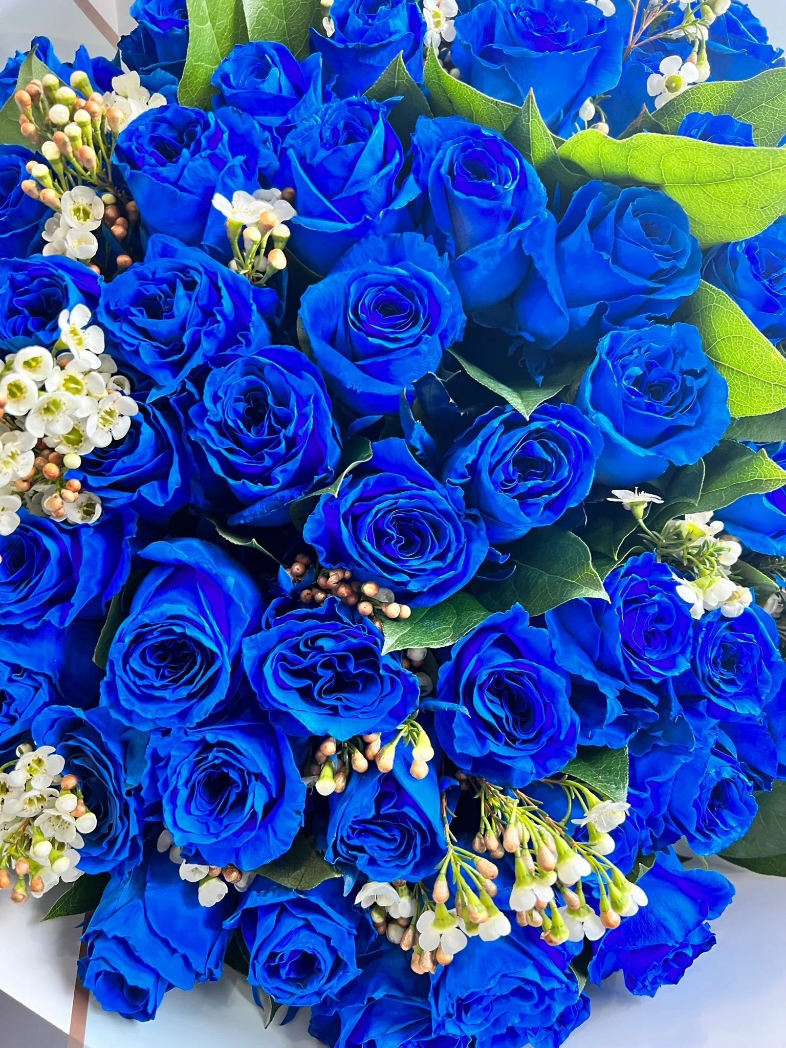 A wrapped Bouquet of Blue Roses for flower delivery in Athens. Looking for a flowers hop near you? Order now.