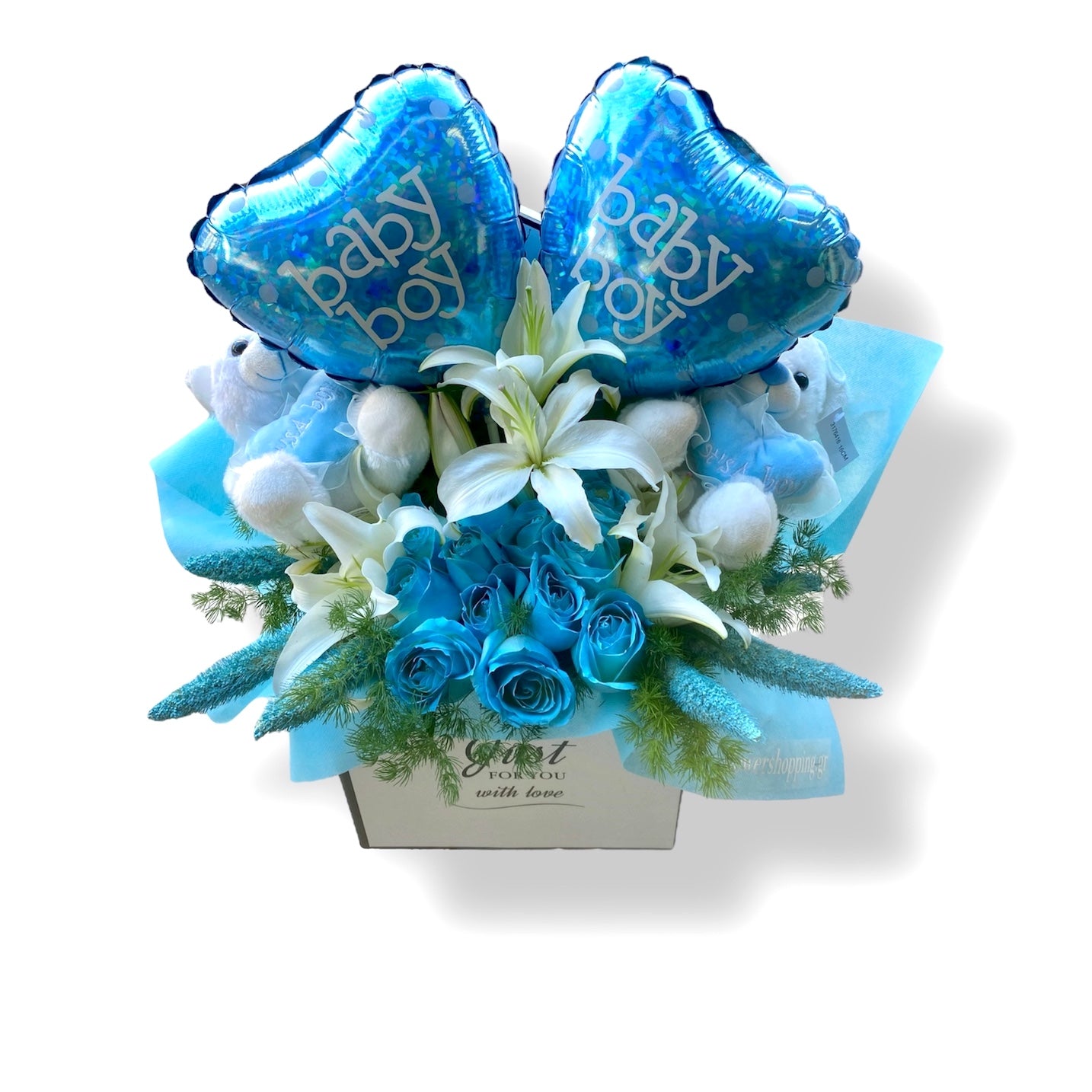 A floral gift basket for a baby boy, featuring a bouquet of blue flowers, white lilies, and two blue teddy bears with the text 'Baby Boy' on them.
