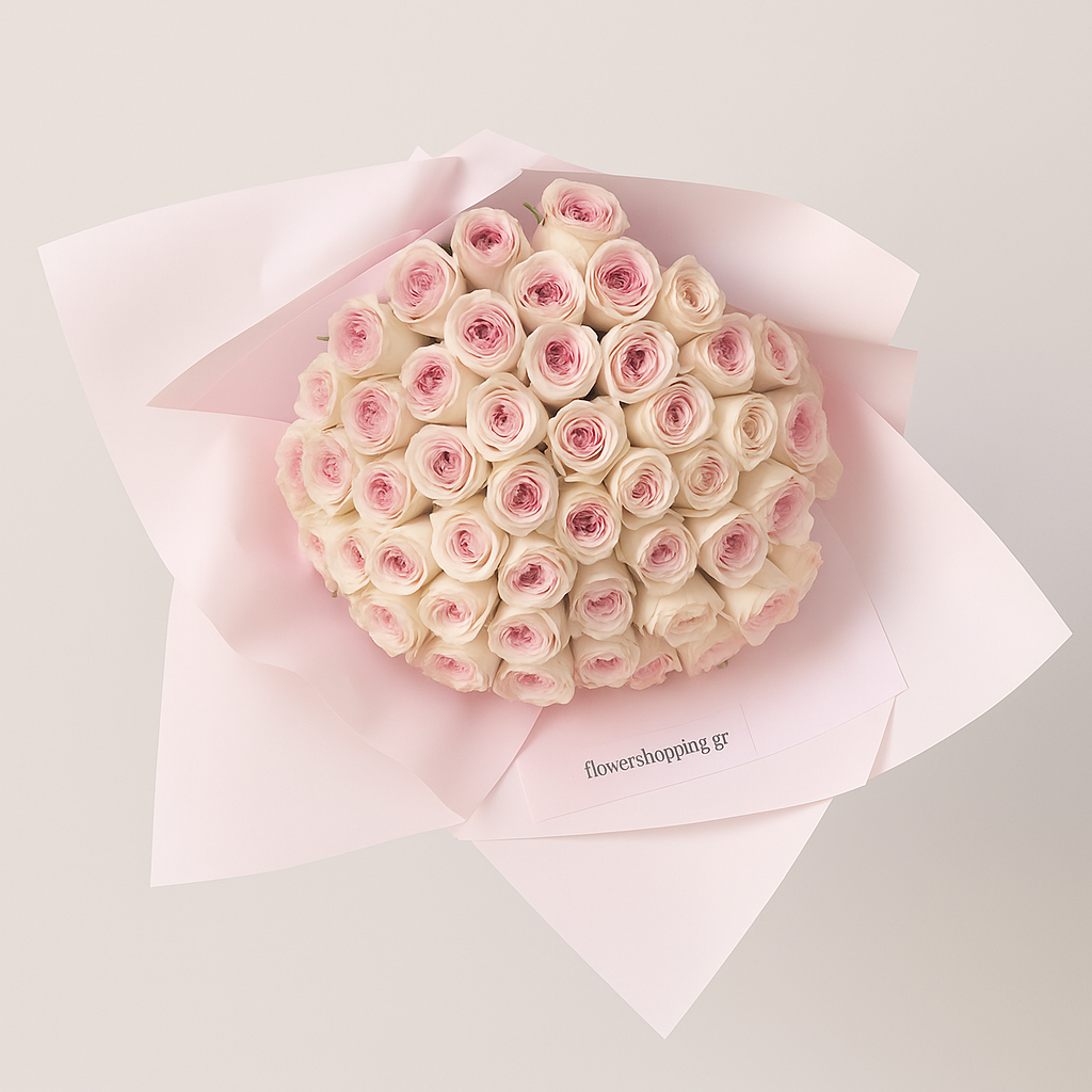 Bouquet of pink and white roses wrapped in pink paper on a light gray background